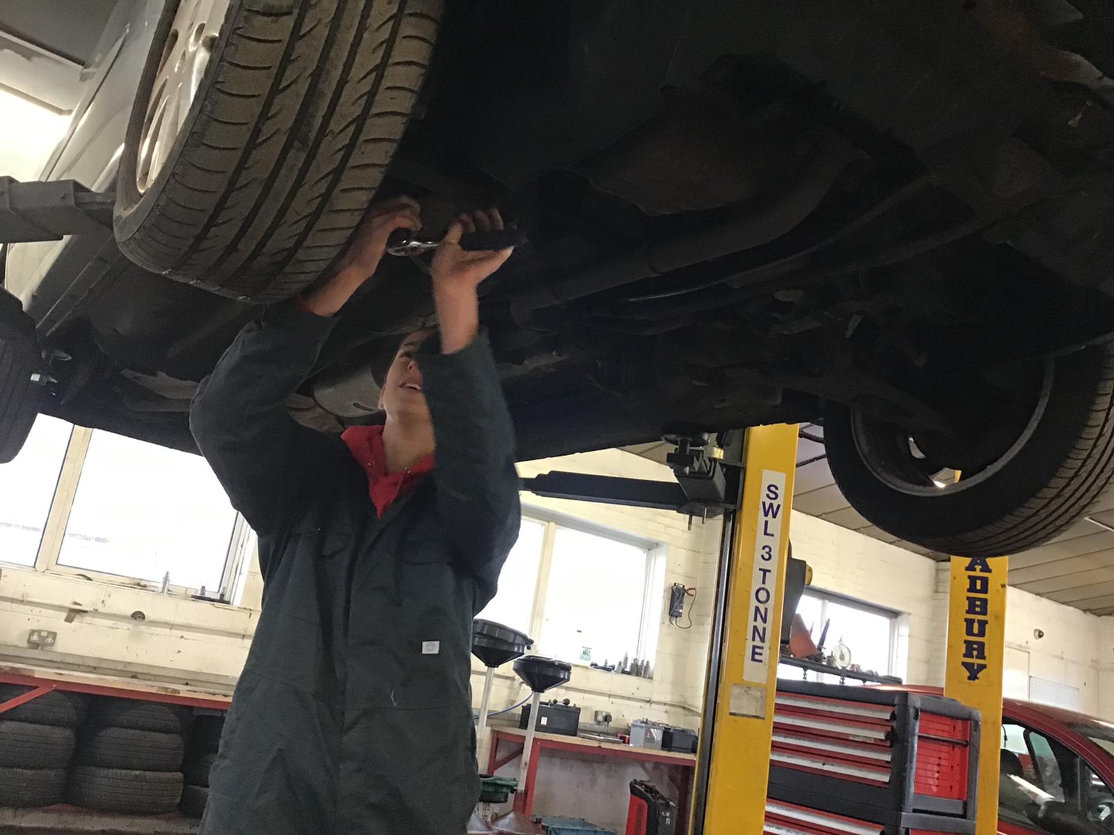 Student working on a car