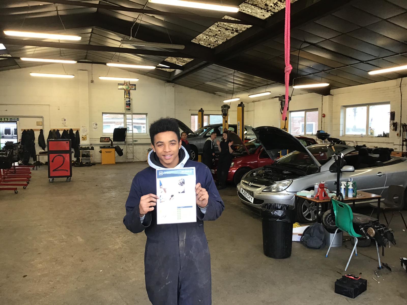 Student holding a certificate