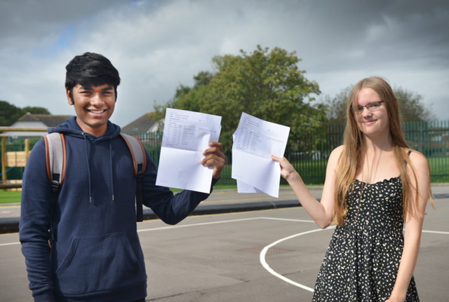 Boy and girl holding results