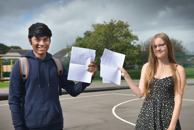 Boy and girl holding results