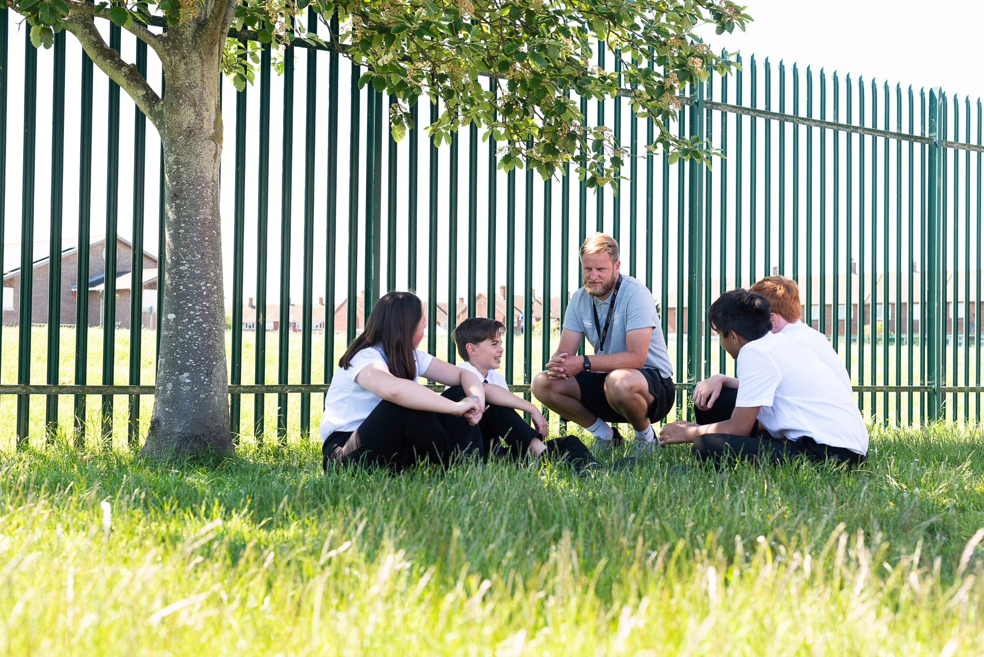 Students sitting with their teacher