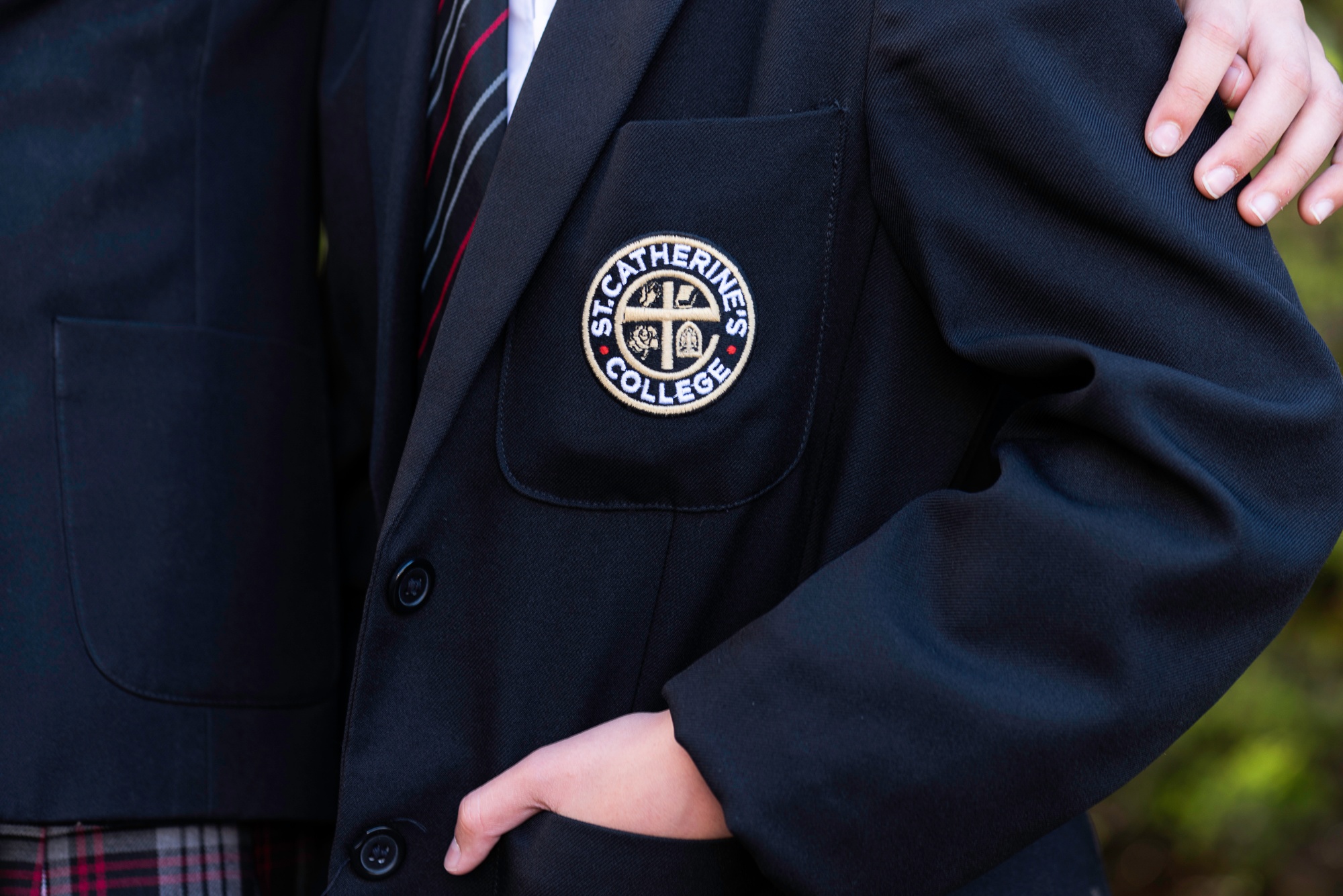 A close up of the school logo on a blazer